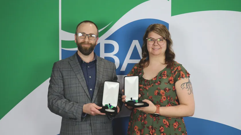 Kyle Schaeffer and Marie Johnson with their 2026 Outstanding Staff awards.