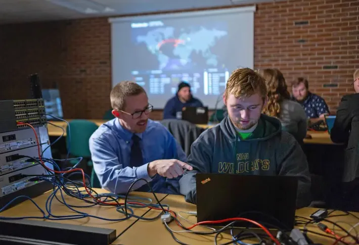 NMU stock photo of Professor Jim Marquardson with a student.