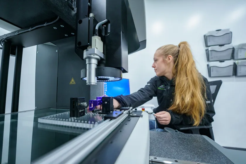 Mount Mfg Production Technician Team Lead Sara Sands operates a CMM machine.