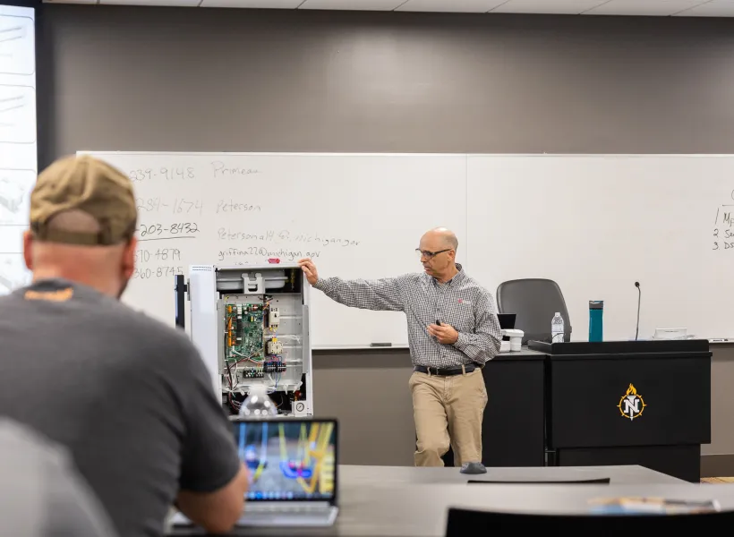 Glen Breaux, Senior Area Service Manager from Mitsubishi Electric, provides training to NMU HVAC/R students and faculty.