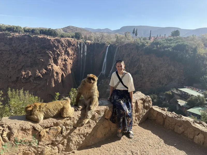 Hamel seated in front of the Ouzoud Waterfalls in Morocco.