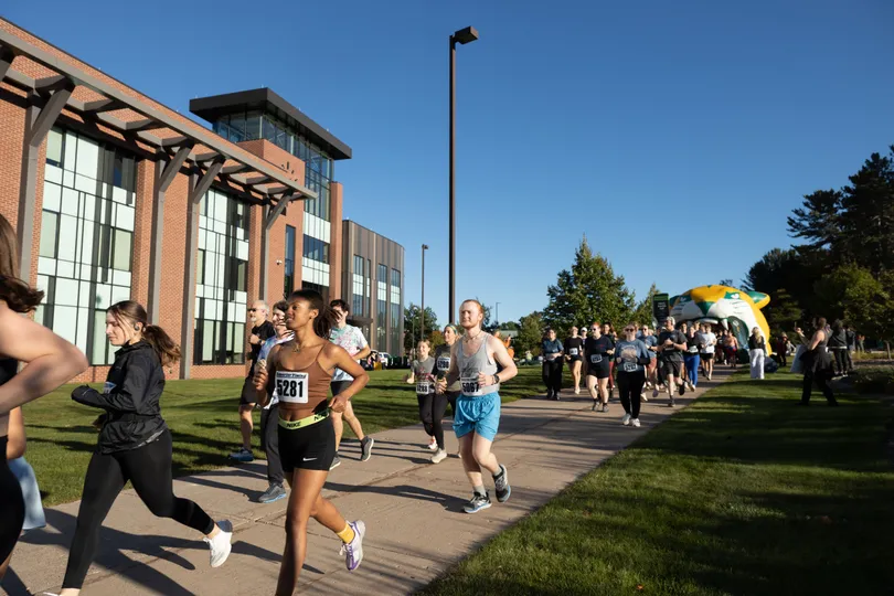 Participants in last year's Mind Over Miles 5K start the race near Jamrich Hall on NMU's campus.