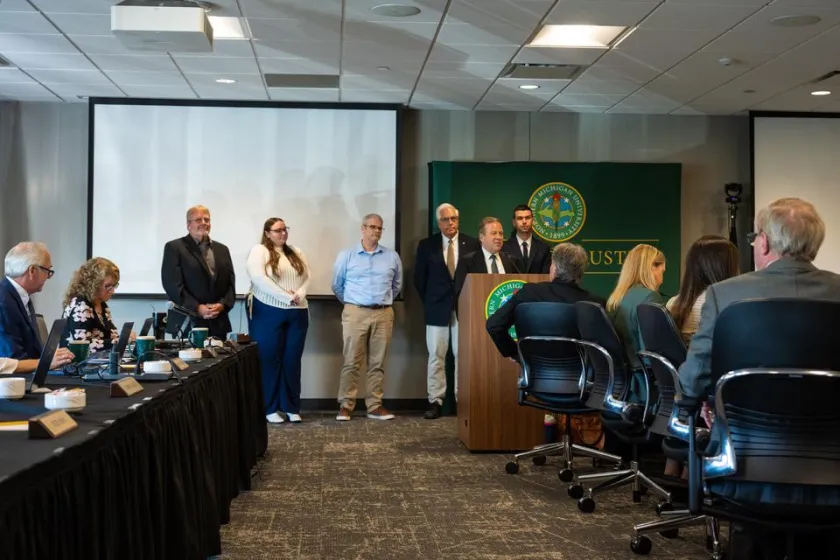 NMU Executive Vice President for Finance and Administration pays special recognition to Educational Access Network staff during the Sept. 18 Board of Trustees meeting. EAN staff in attendance were, from left, Don Salo, Lauren Polick, Chris Lewis, Eric Smith and Matt Franti.