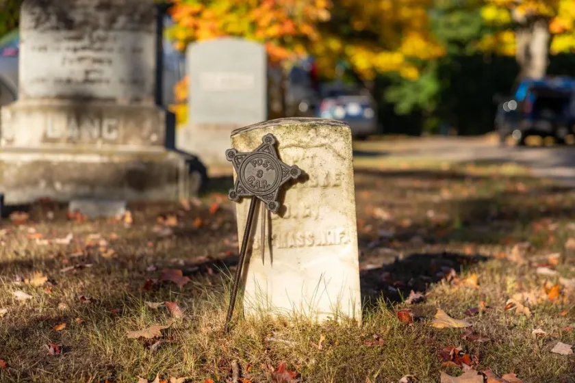 The gravestone of Civil War veteran Capt. E. W. Fiske. Fiske's marker, along with 12 other markers of Civil War veterans, were cleaned by volunteers from NMU.