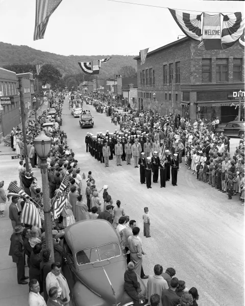 A 1955 parade moves through downtown Munising. Photo courtesy of Superior View Archive.