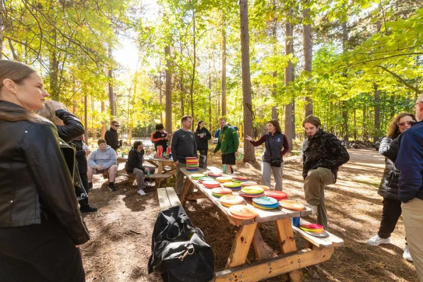 Finnish visitors play disc golf with NMU representatives