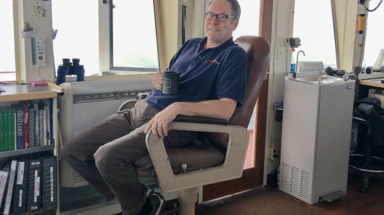 Hughes relaxing in the captain's seat