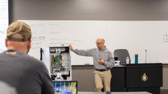 Glen Breaux, Senior Area Service Manager from Mitsubishi Electric, provides training to NMU HVAC/R students and faculty.