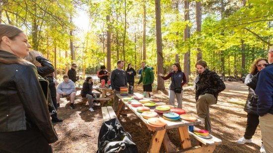Finnish visitors play disc golf with NMU representatives