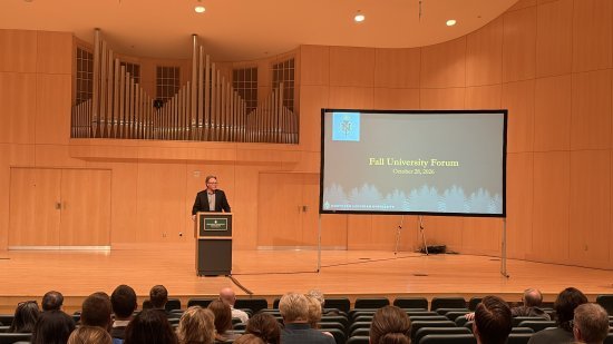 NMU President Chris Olsen addresses the group gathered in Reynolds Recital Hall for the fall university forum