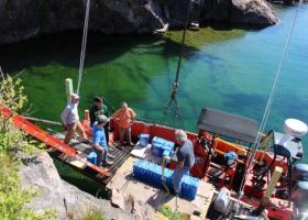 Image of members unloading batteries from a boat