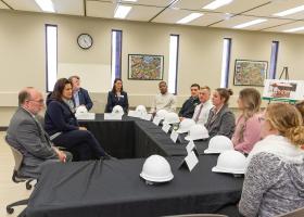 Governor with students and administrators