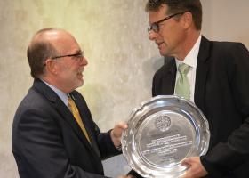 Mommaerts (right) receives his award from NMU President Fritz Erickson