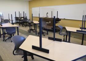 Classroom with plexiglas barriers on tables
