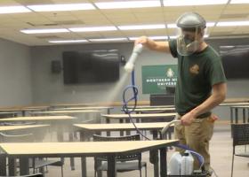 A staff member applies MicrobeCare