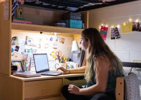 Student studying in residence hall (stock photo)