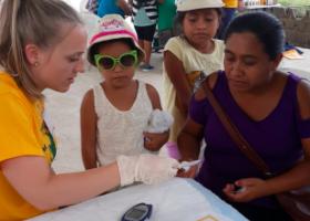 NMU community health graduate Erin Messerschmidt at a community health fair in Belize, May 2019.