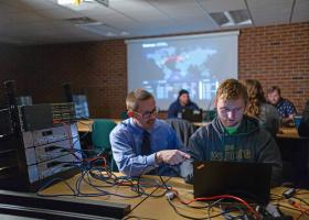Marquardson (left) with a student (file photo from 2018)