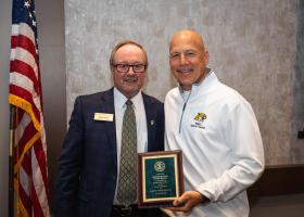 Popp (right) with NMU Board Chair Steve Young