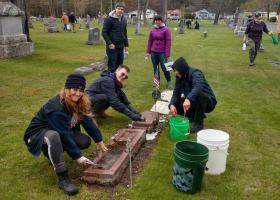 Volunteers cleaning tombstones