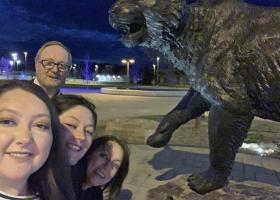 A selfie of the Young family by the wildcat statue on campus