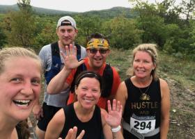 White (front center) with SLEPS colleagues and her husband completing the Four Peaks trail run last summer.