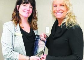 Daust (right) receiving the award from Evergreen Committee Chair Kori Bjorne