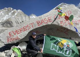 Gonzalez displays an NMU flag upon reaching Everest Base Camp