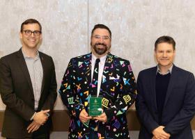 Digneit (center) with President Brock Tessman and Interim Provost Dale Kapla