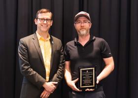 Buckmaster (right) with President Brock Tessman