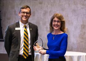 Dr. Ellen Narotzky Kennedy accepts the Distinguished Alumni Award from NMU President Brock Tessman