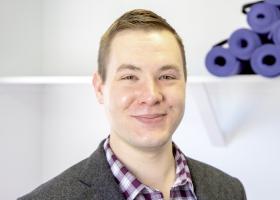 Mitchell Stephenson accepts the NMU Outstanding Young Alumni Award from NMU President Brock Tessman