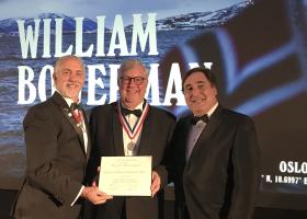 Bowerman (center) being presented with the medal and certificate for the Lowell Thomas Award by The Explorers Club President Richard Garriott (left) and Vice President for Flags and Honors Martin Nweeia (right).