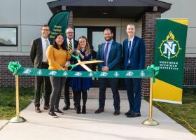 (From left): NMU President Brock Tessman, master's student and Registered Behavior Technician Cheyenne Nutlouis, Board Chair Steve Young, Zoe Broadus, Director Jacob Daar and Adam Prus, chair of the Department of Psychological Science.