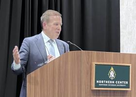 Leach addresses the budget at the forum.