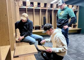 (From left): Kyle Sahr, Trent Kantola and Luke Pettinger installing locker shelves.