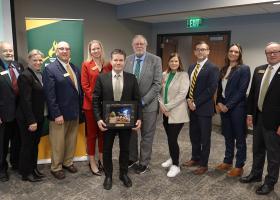 Interim Provost and VP for Academic Affairs Dale Kapla received a special recognition from the board for his service. He is pictured front and center with (back row from left): Trustees Steve Lindberg, Alexis Hart, Greg Toutant, Missie Holmquist, Greg Seppanen and Lisa Fittante, NMU President Brock Tessman, and Trustees Brigitte LaPointe-Dunham and Steve Young.