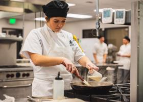 Hospitality Leadership student preparing food (NMU stock photo)