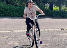 Happy student Trinity Valentin tests out her new bike.