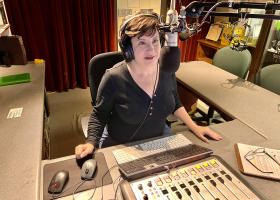 Nicole Walton behind the microphone in the Public Radio 90 studio.
