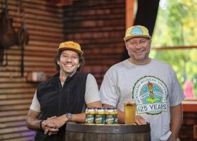 Left to right: NMU alumni Steve Farr (’09 BS, ’12 MBA), Blackrocks' "Pirate of Propoganda" and Andy Langlois ('95 BS), Blackrocks co-owner, with the branded Wildcat Gold Lager cans.