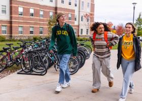 NMU stock photo of students walking on campus