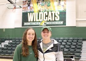 Makaylee Kuhn and Sarah Kuehn in Vandament Arena, home court for NMU volleyball and basketball.