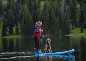 Mathewson practicing self-care on a paddleboard with her standard poodle (Top O' the World student newspaper photo)