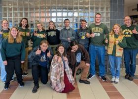 Members of the three NMU Quiz Bowl squads pictured with coach Michael Joy at right.