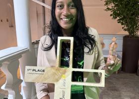 Niyomi House with a first-place plaque from the XPRIZE Rainforest competition.