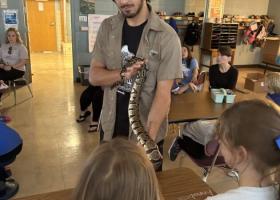 Zivnoska with a snake during a presentation