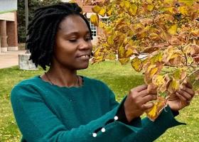 Ugandan visiting scholar Justine Nakintu on campus last semester exploring the fall leaves.
