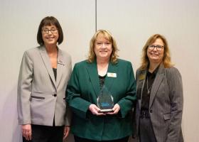NMU Center for Rural Health Director Elise Bur (center) is pictured holding the Nonprofit of the Year Award with Holly Peoples (left) and Debb Brunell, both of Upper Peninsula Michigan Works!, a UPEDA member