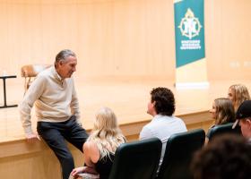 Howard Schultz, Starbucks chairman emeritus and former CEO, interacting with NMU students during a visit to campus in October 2024.